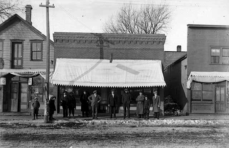 People posed in front of business, Albany Minnesota, 1915