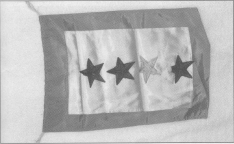 This Gold Star Mother's Flag was owned by Mrs. Axel Clausen. Her son, Leland, was killed in WWII. Three other sons (the blue stars) also served: Carl, Lester, and Walter