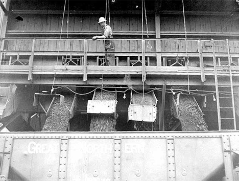 Washed ore being loaded into seventy-ton cars at a concentration plant to be transported to Duluth and Superior docks, Bovey Minnesota, 1941