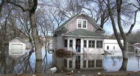 Jeff Backer, mayor of Browns Valley, Minn., looks outside his front door on March 14, 2007, after melting snow and ice jams flooded the town.