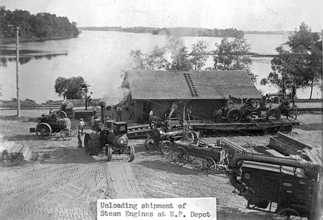 Unloading shipment of steam engines at Northern Pacific Depot, Center City, 1890