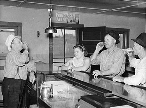 A drink on the house. Lumberjacks, proprietor and lady attendant in saloon. Craigville, Minnesota, 1937