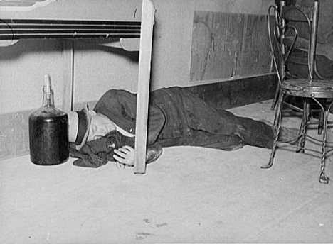 Lumberjack under the table in a saloon in Craigville Minnesota, 1937