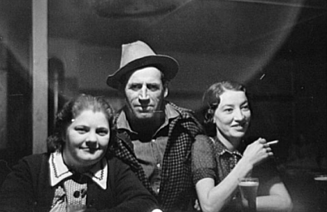 Lumberjack and two "attendants" in saloon of Craigsville Minnesota, 1937