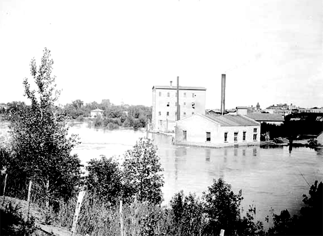 "Old dam" at Crookston, showing power house and Crookston Roller Mill, 1900