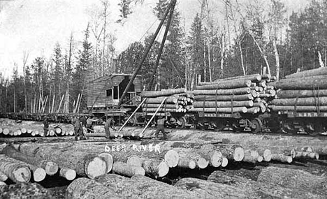 Men loading logs on flat cars, Deer River Minnesota, 1915