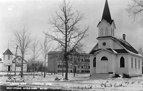 Street view showing high school, grade school, and a church at Deerwood, 1915