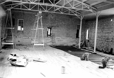 Installing floor, new gymnasium addition to school, Emmons Minnesota, 1936