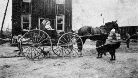 Joe Weichselbaum and son, Walter in front of the Scott Hotel in Gemmell Minnesota, 1910