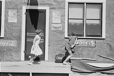 Children playing outside a saloon in Gemmell Minnesota, 1937