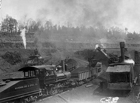 Loading railroad cars with ore in the Mahoning Mine, Hibbing Minnesota, 1898