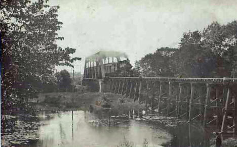Train crossing bridge, Lyle Minnesota, 1915