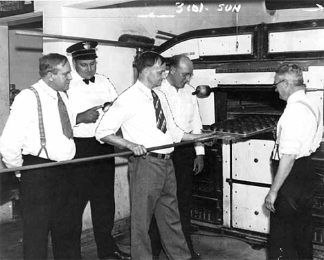 Taking a batch of Kolackies out of the oven, 1933 "Kolacky" Day, Montgomery Minnesota, 1933