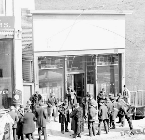 Crowd of men in front of Fred Ambs saloon, Moorhead Minnesota, 1900's
