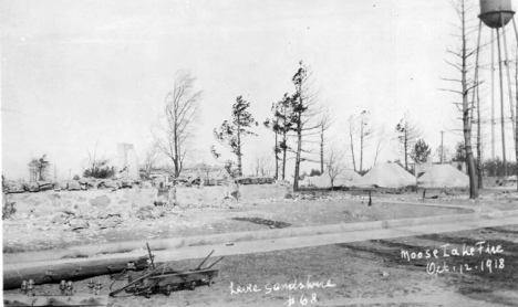 Ruins with refugee tents in background after the fire, Moose Lake Minnesota, 1918