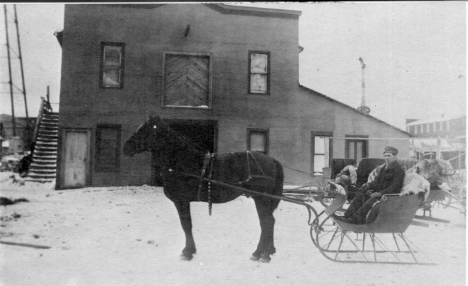 Granville Dauphnee in front of his livery barn, Northome Minnesota, 1910