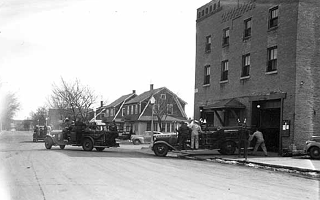 Fire trucks leaving station, Sauk Centre Minnesota, 1942