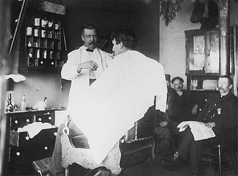 Barber cutting man's hair, Swanville Minnesota, 1900