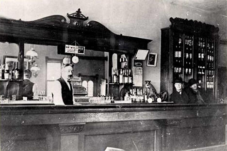 Visitors and bartender inside the Harris Saloon, Tenstrike Minnesota, 1905
