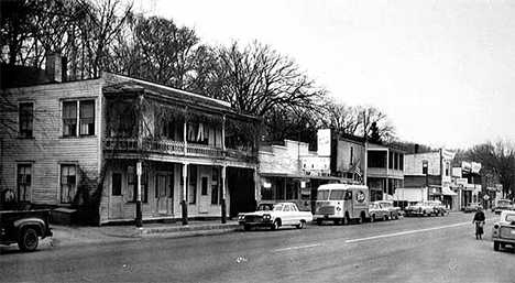 Street in Zumbro Falls showing overhanging porches, 1964