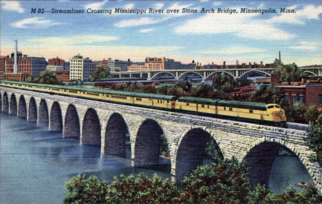 Streamliner Passenger Train crossing Mississippi River over Stone Arch Bridge in Minneapolis Minnesota, 1943