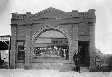 Clyde Hewitt in front of the Nassau State Bank, Nassau Minnesota, 1912