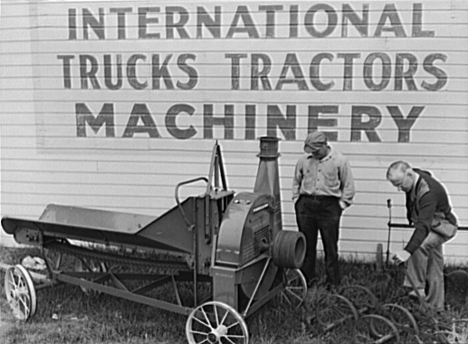 Itasca County FSA Supervisor looking over used farm machinery with client, Grand Rapids Minnesota, 1939