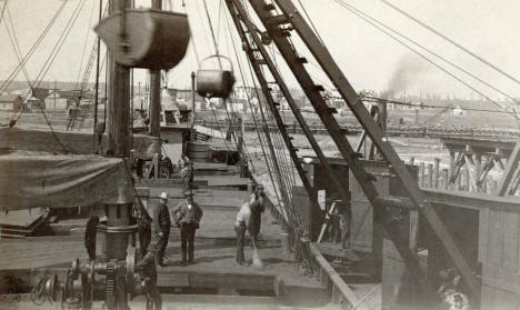 Vessel deck and workers at coal dock, Two Harbors, Minnesota, 1890