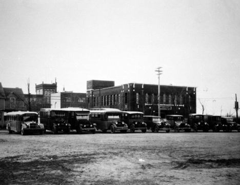 Parked Virginia School District buses, behind Roosevelt Grade School, 1920's