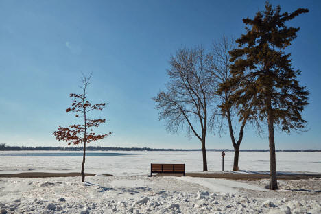 Bench along frozen Lake Okabena in Worthington Minnesota, 2020