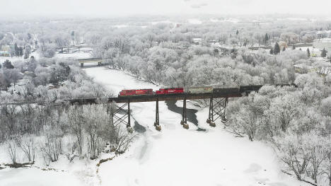 A Canadian Pacific freight train crosses the trestle over the Crow River in Rockford, MN. On this Saturday morning, hoar frost blanketed the area. 2021