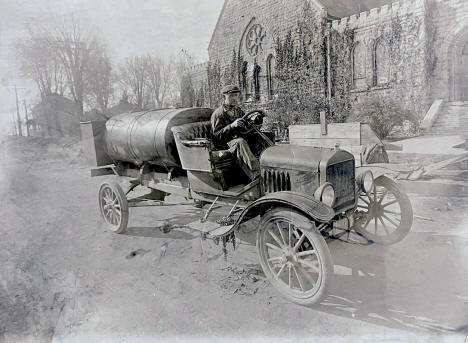 Oil delivery truck in front of St. John the Baptist Church, Caledonia Minnesota, 1920s